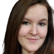 A photo of a woman with dark reddish, brown hair in front of a white background.
