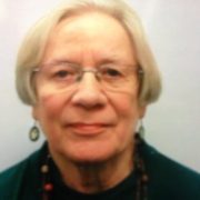 A photo of a woman with light blonde hair and glasses.